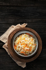 Sauerkraut on wooden background.