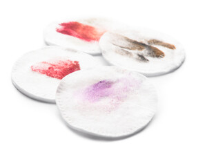 Dirty cotton pads after removing makeup on white background