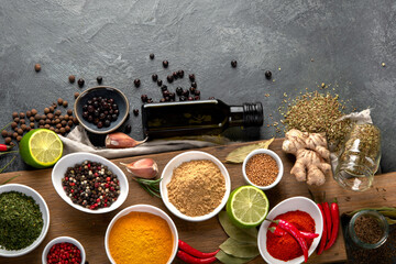Assortment of spices on gray background.