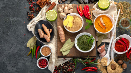 Assortment of spices on gray background.