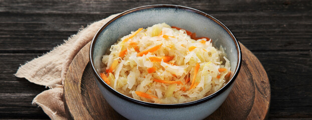 Sauerkraut on wooden background.