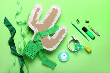 Preparation of Mexican pinata on color background