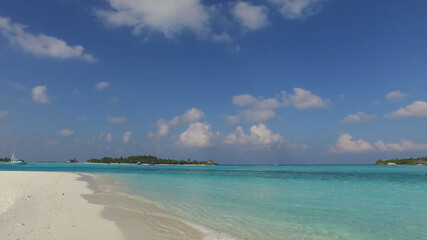 Coastline, sandy beach, turquoise water, islands in the distance