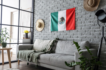 Interior of stylish room with Mexican flag on bricks wall