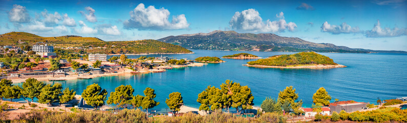 Panoramic seascape of Ionian sea with Corfu island on background. Wonderful spring view of Ksamil village. Spectacular outdoor scene of Albania, Europe. Traveling concept background.