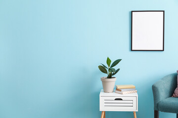 Blank poster on color wall in interior of stylish room