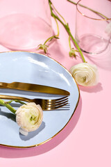 Beautiful table setting and ranunculus flowers on color background