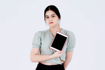 Portrait studio shot of Asian young teenager female model with ponytail hairstyle wearing dental care teeth braces and crop top outfit standing pointing blank screen tablet on white background