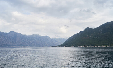 Fototapeta na wymiar Seascape with mountains and rainy weather in Montenegro