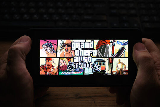 Kostanay, Kazakhstan, November 04, 2021.A man holds a mobile phone with a screensaver of the popular Grand Theft Auto: San Andreas game.