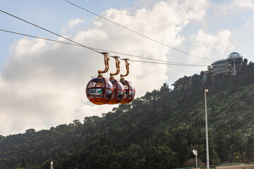 Cable car cabins move from the lower station on the waterfront to the upper station on Mount Kamel in Haifa city, northern Israel