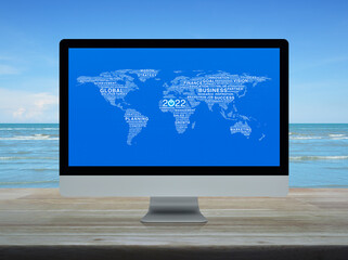 Start up business icon with global words world map computer screen on wooden table over tropical sea with blue sky, Happy new year 2022 global business start up online concept, Elements of this image 