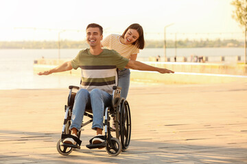 Young man with physical disability and his wife outdoors