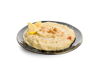 Plate with delicious hummus and lemon on white background