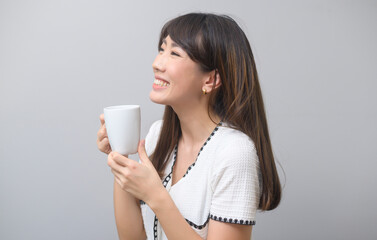 Portrait of young beautiful woman having a cup of coffee