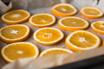 Oranges on a dish prepared for drying. Bright juicy orange slices. Fruit
