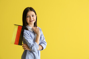 Pupil of language school with German flag on color background - obrazy, fototapety, plakaty