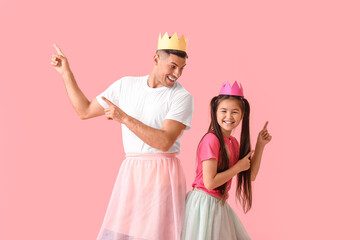 Dancing man and his little daughter on color background