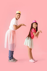 Dancing man and his little daughter on color background