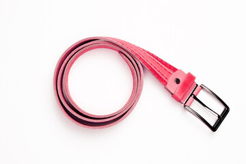 Rolled up red belt with a metal buckle on a white background.