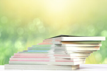 books on reading table with natural bokeh background. concept of learning and education