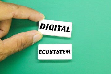hand holding a colored board with the word digital ecosystem