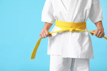 Türaufkleber Little boy in karategi on color background © Pixel-Shot