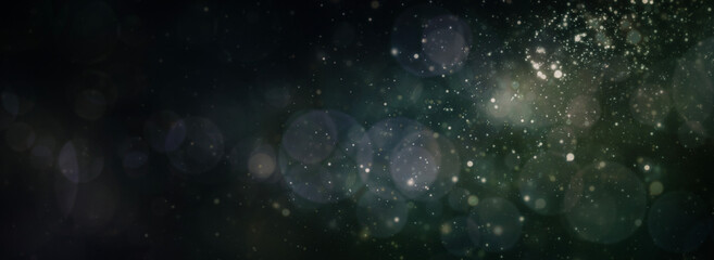 Abstract magic sparks light and snow circular bokeh New year Christmas background.