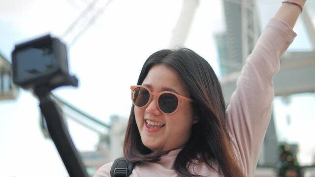 A traveler asian female talking with camera selfie with cheerful move around to show the place of vacation weekend devide happiness travel concept