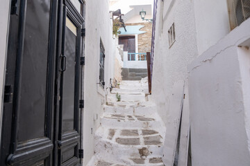Cyclades, Greece. Ios, Nios island, Chora. Whitewashed buildings and narrow cobblestone alley.