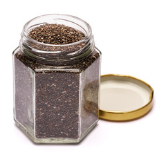 glass can full of organic natural chia seeds close-up isolated on white background