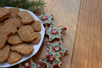 Traditional cookies from northern europe called Speculoos on wooden table. Festive cookies made with spices with festive decorations