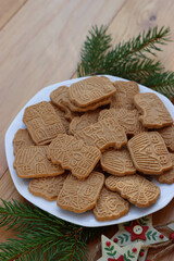 Traditional cookies from northern europe called Speculoos on wooden table. Festive cookies made with spices with festive decorations