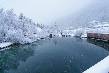 frozen pond with snow in ortler valley, south tyrol