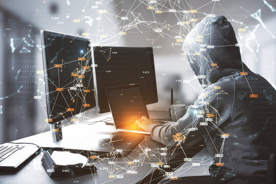 Hacker at table using computers with creative glowing big data connections circle on blurry interior background. Science, hacking, malware, digital network and technology concept.