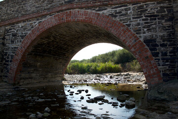 Fototapeta na wymiar Harlyn Bay pack horse bridge masonry arch north Cornwall England uk 