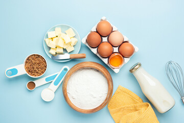 Ingredients for baking a cake on wooden table background, flat lay, copy space for text recipe or design