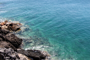 background of beautiful photography of the rocky coast of the clear blue sea