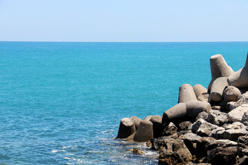 background of beautiful photography of the rocky coast of the clear blue sea
