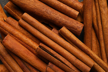 Natural cinnamon sticks as background, closeup