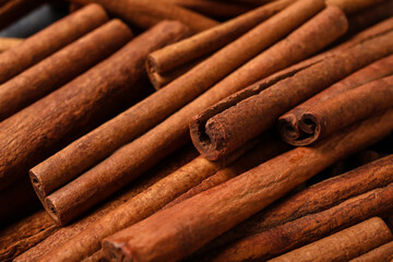 Natural cinnamon sticks as background, closeup