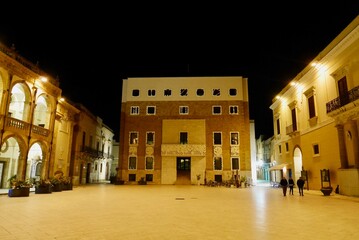 Illuminated main square (Piazza della Repubblica) of Mazara del Vallo with Palazzo del Seminario and town hall at night in Trapani province, Sicily, Italy.