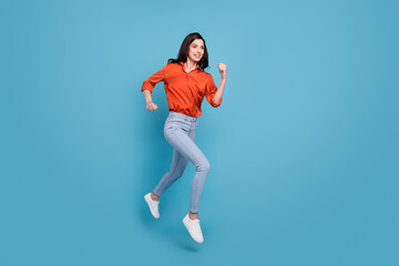 Fototapeta na wymiar Full length body size view of attractive cheery motivated girl jumping running isolated over bright blue color background