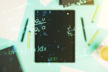 Double exposure of creative scientific formula concept and digital tablet on background, top view,...
