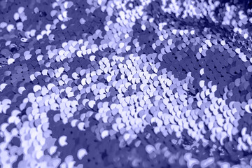 Trendy Color of the Year 2022 very peri. Abstract shiny sequins fabric background with copy space. Purple fashion glittery scales