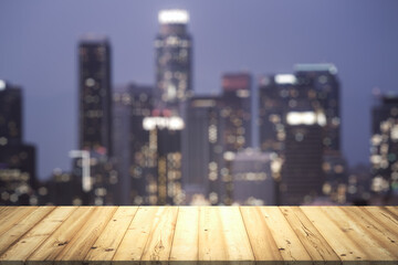 Table top made of wooden dies with blurry city view at dusk on background, template