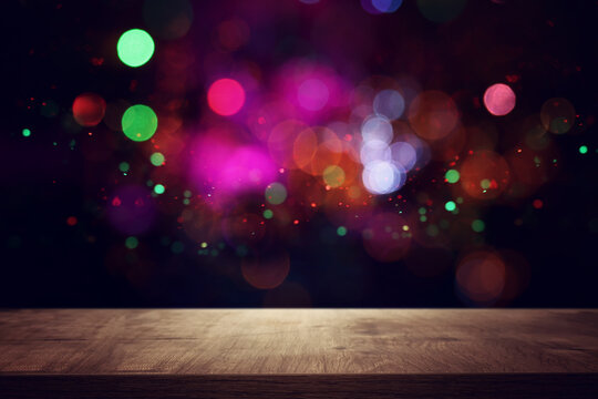 background Image of wooden table in front of abstract blurred lights