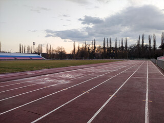 Running tracks in the stadium in evening in winter