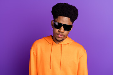 Photo of young serious dark skin cool man wear sunglass charming face youngster isolated on violet color background