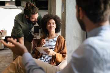 Portrait of creative business people team working together and smiling in office.